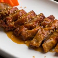 Duck Tamarind · Boneless duck served with homemade tamarin sauce and steamed vegetable top with garlic. Serv...