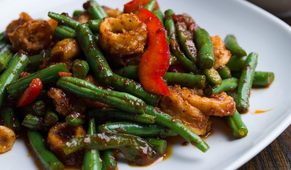 Crispy Pork Prik Khing · Sauteed fried crispy pork with chili paste, green bean bell pepper served with teamed jasmine rice. Spicy.