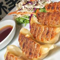 Pan Fried Dumplings · Mouth watering, soft, pan fried shrimp dumplings with traditional dipping sauce.