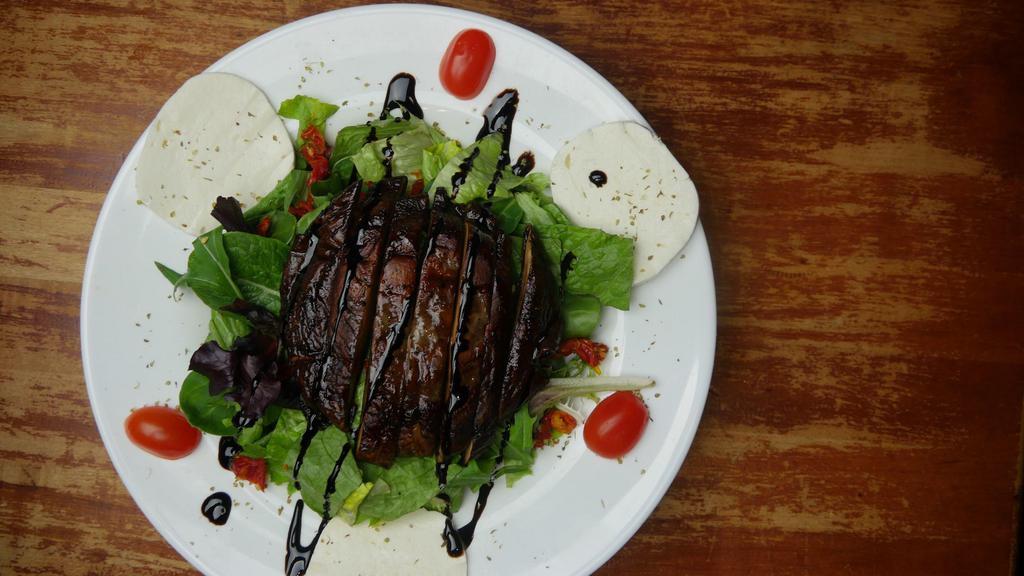 Portobello Mushroom Salad · House-made fresh Mozzarella, chopped sundried tomatoes, with marinated and grilled portobello mushrooms, over mixed greens with our own balsamic dressing.