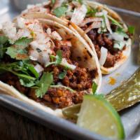 Chorizo Taco · House made Mexican spiced sausage, smoked paprika, onion, and cilantro.