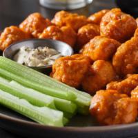 Mild Wings - Boneless · Classic boneless wings oven-baked, topped with Mild hot sauce, cooked to order and perfectly...
