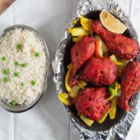 Tandoori Chicken · Chicken marinated in yogurt, garlic, ginger, spices, and fresh herbs. Served with rice.