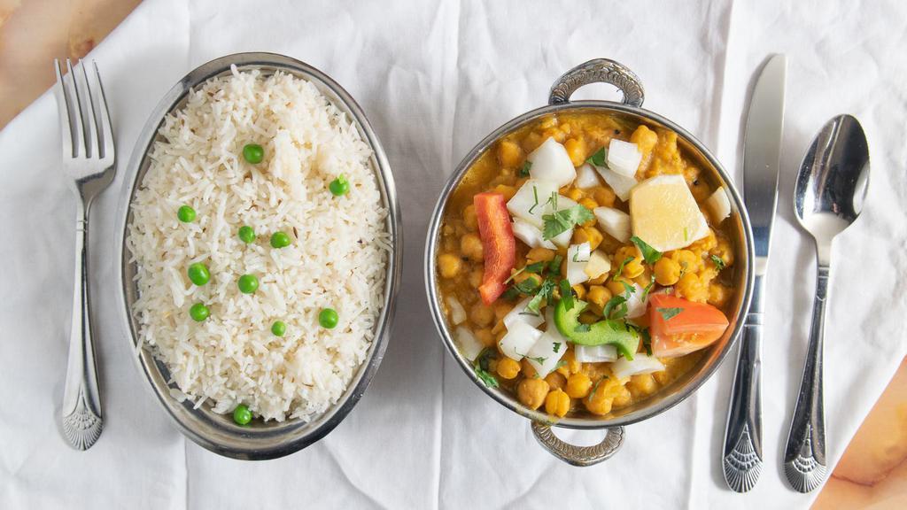 Chana Masala · Vegan. Chickpeas cooked with onions, tomatoes, ginger, garlic, and spices. Served with rice.