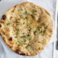 Garlic Naan · Naan topped with garlic and cilantro. Indian bread prepared in a clay oven.