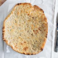 Peshawari Naan · Naan stuffed with coconut, raisin, pistachios, and homemade cheese. Indian bread prepared in...