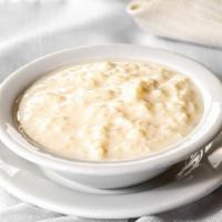 Kheer · Creamy rice pudding garnished with pistachios.