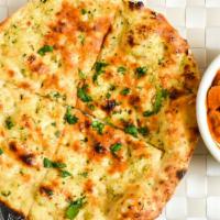 Garlic Naan · Flat bread with garlic, herbs cooked in a clay oven