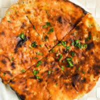 Qeema Naan · Flat bread stuffed with ground chicken, herbs and spices cooked in a clay oven
