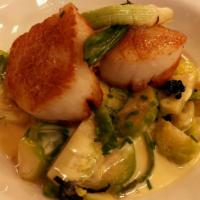 Caramelized Diver Scallops · with spring vegetables ragout and garlic vinaigrette.