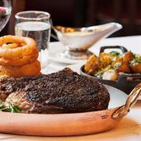 Dry-Aged Côte De Boeuf* · With Balthazar onion rings and Bordelaise sauce. For two.

Eating raw or undercooked fish, s...