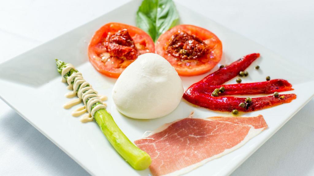 Burrata · Cream Mozzarela Cheese served with tomato's, asparagus, and roasted peppers.