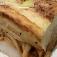 Pastitsio · Baked pasta with ground beef and topped with white cream sauce. Served with a small salad an...