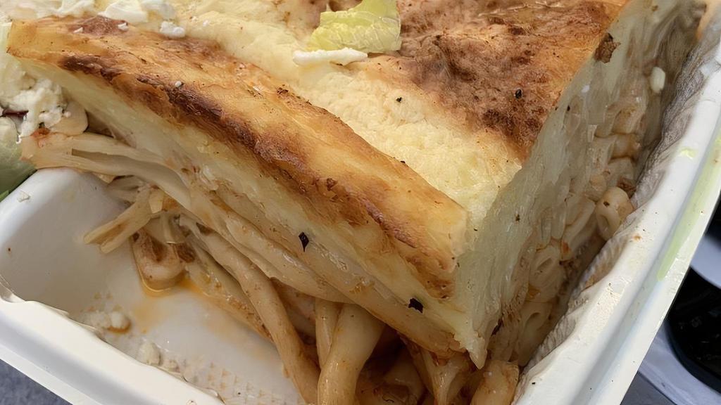 Pastitsio · Baked pasta with ground beef and topped with white cream sauce. Served with a small salad and choice of side.