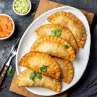 Empanadas · Corn shells stuffed with beef and
vegetables or with chicken and potato,
served with a light...