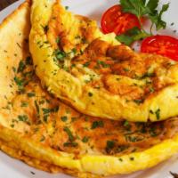 The Cheese Omelet · Fluffy scrambled eggs stuffed with melty American cheese.
