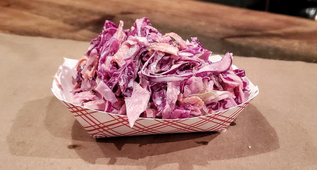 House Made Coleslaw · Our colesalaw is made with red & green cabbage, shredded carrots, and celery seed, tossed in our homemade vinegar & white sauce.  (contains mayo).