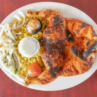 Charcoal Chicken Platter · Full charcoal grilled chicken sided with a side of yellow rice and garlic sauce and fresh pi...