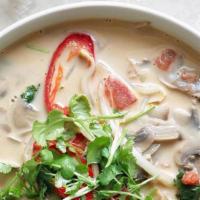 Tom Kha · THAI GINGER SOUP: Tom yum broth lightly sweetened with creamy coconut milk. Garnished with g...
