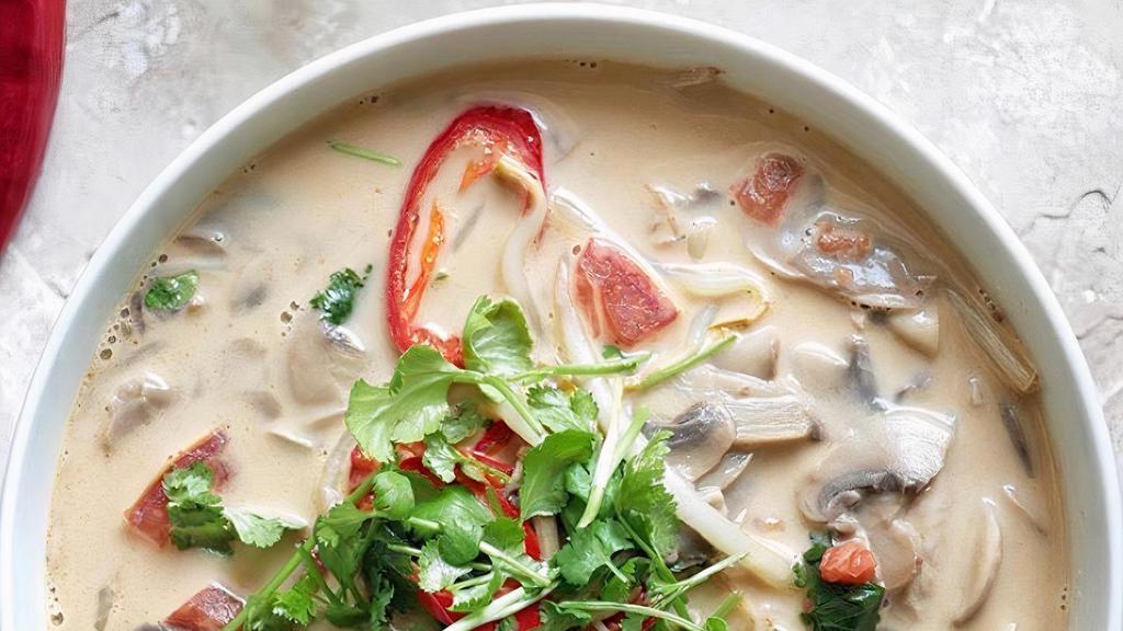 Tom Kha · THAI GINGER SOUP: Tom yum broth lightly sweetened with creamy coconut milk. Garnished with green onions and cilantro.