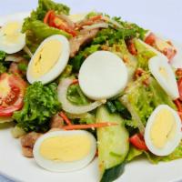 Mama Olay'S Salad · Lettuce, cucumbers, carrots, onions, tomatoes, cilantro tossed in mama olay's vinaigrette dr...