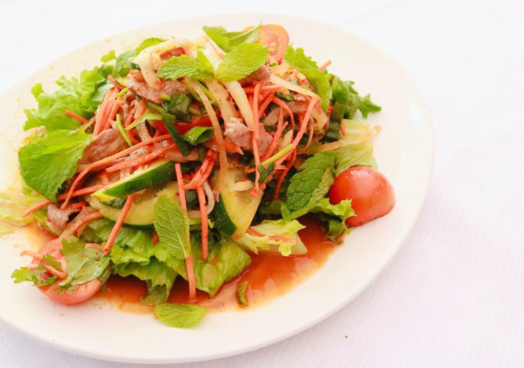 Yum · THAI SALAD: Tomatoes, onions, cucumbers, cilantro, and mint tossed in fresh lime juice, thai herbs and spices. Served atop a bed of lettuce.