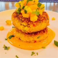 Crab Cakes · Pan-fried crab cakes flavored w/ lime zest, sweet peppers, served on top of chipotle mayo, t...