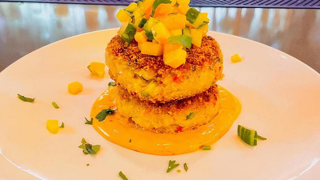 Crab Cakes · Pan-fried crab cakes flavored w/ lime zest, sweet peppers, served on top of chipotle mayo, topped w/ mango cucumber salsa