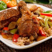 Brown Stew Chicken · Tender brown stewed chicken drenched in a rich and thick gravy -Served with Rice & Peas or W...