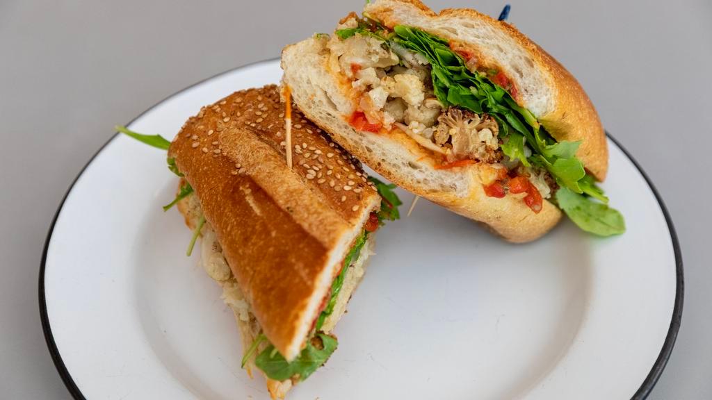 Uncle Chucky · Vegan. House-roasted cauliflower, pumpkin seed romesco, pickled fennel, arugula, onion, and sumac vinaigrette on Caputo's seeded club roll. Gluten-free bread contains egg whites.

**Please note: we are currently out of gluten free bread**