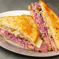 The Delight · House-corned short ribs, Swiss cheese, coleslaw, and guss’ full sour pickles on Orwasher's r...