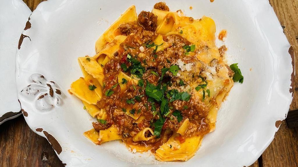 Pappardelle Alla Bolognese · Handmade pasta, veal, beef and pork ragu.
