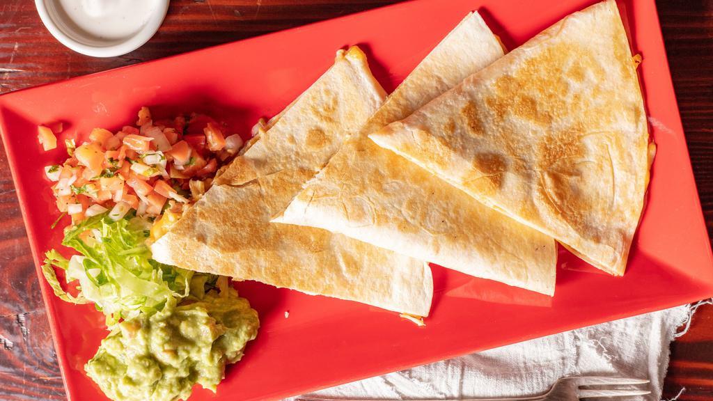 Super Quesadilla
 · A large flour tortilla with your choice of filling served with pico de gallo, guacamole and crema.