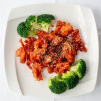 Sesame Chicken · Fried slices of white meat chicken in a tangy chef sauce on top of broccoli.