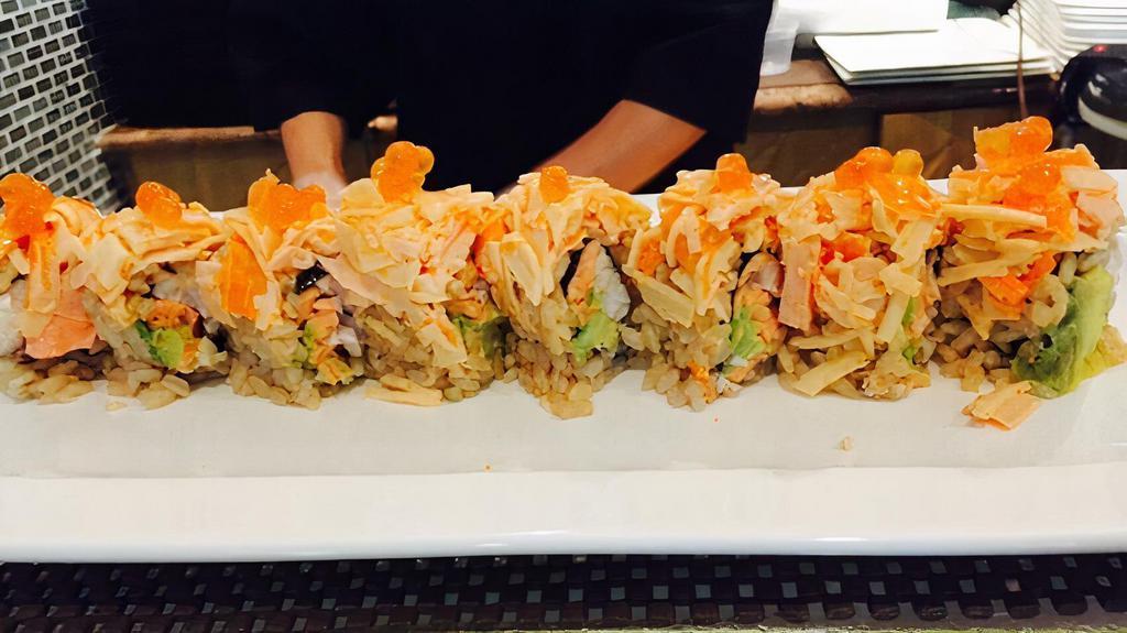 Kai Fan Roll · Salmon, yellowtail and avocado inside topped with spicy kani, ikura and sweet miso sauce.