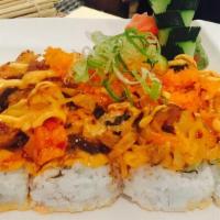 Volcano Roll · Cooked salmon and avocado inside topped with broiled spicy kani, mushrooms and masago with s...