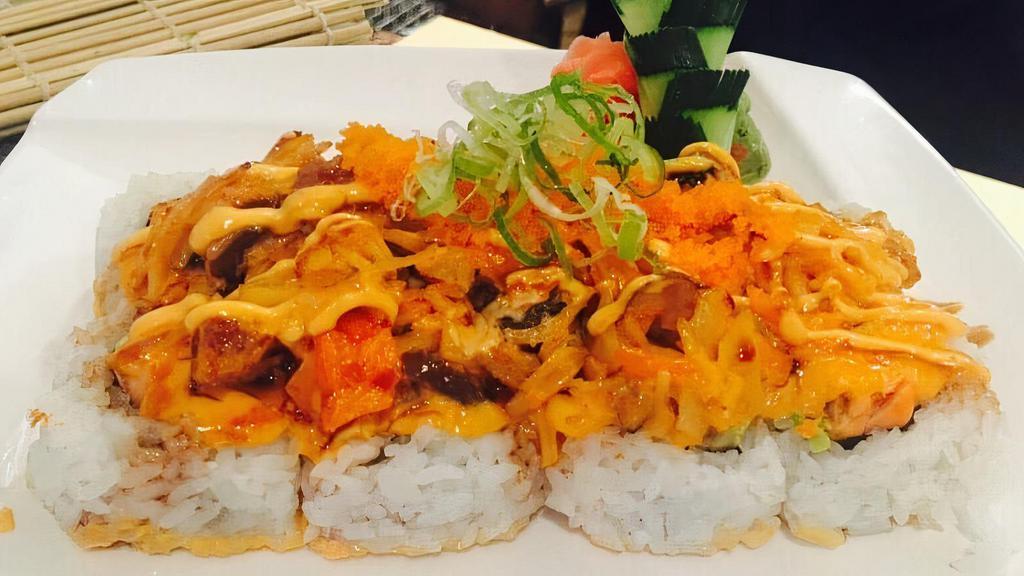 Volcano Roll · Cooked salmon and avocado inside topped with broiled spicy kani, mushrooms and masago with spicy mayo and eel sauce.