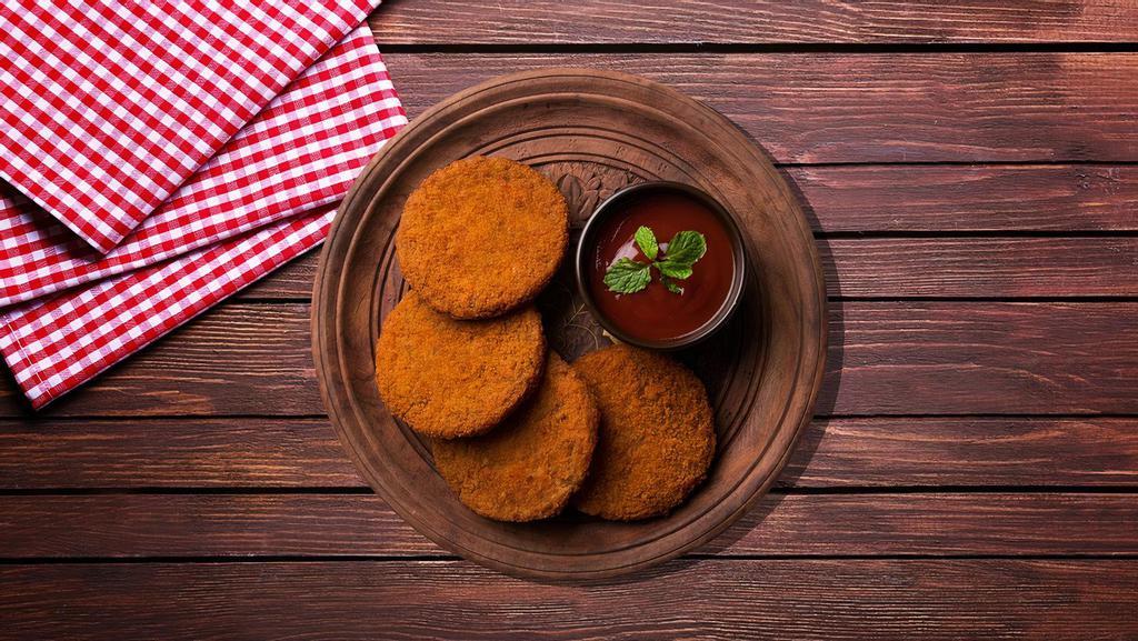 Famous Aloo Tikki · A golden fried-potato patty that stuffed with peas and dal and served with a variety of spicy chutneys