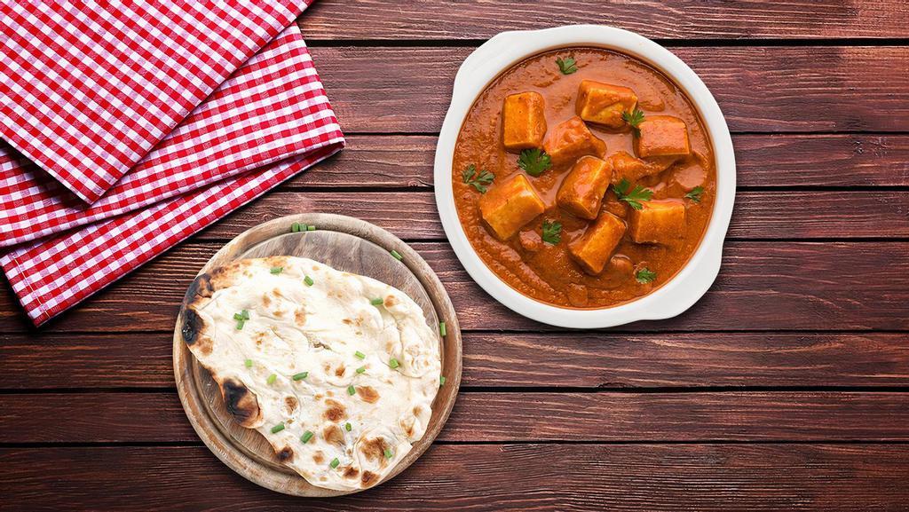 Butter Cottage Cheese & Naan Bread · Rich and creamy dish of cottage cheese cooked in a tomato, butter and cashew sauce, served alongside naan breads.