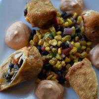 Southwest Chicken Spring Rolls · Corn + black bean salsa, mexican cheese blend, chipotle crema.