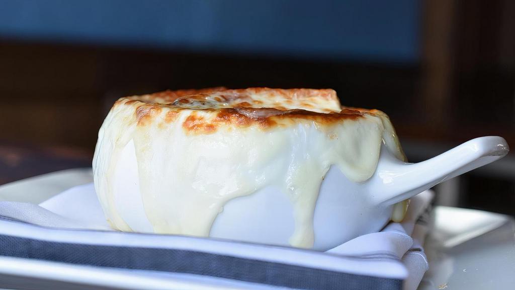French Onion Soup · Toasted baguette, caramelized mozzarella + swiss.