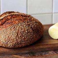 Sourdough · SheWolf Bakery's Sesame Miche bread with four ounces of house cultured butter.