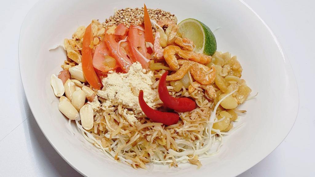 Ginger Salad (Ginn Thoke) · Shredded pickled ginger combined with cabbage, tomato, crispy mixed bean, fried garlic, sesame seed, peanut, corn, chickpea powder with a splash of fish sauce and lime juice