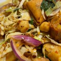 Samosa Salad · Mixture of cut Samosas with cabbage, lime, and spices on top