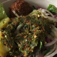 Falafel · Tahini, chopped salad, and pickles.