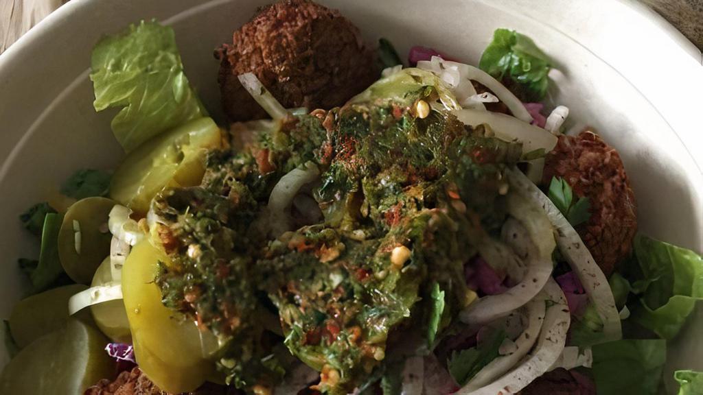 Falafel · Tahini, chopped salad, and pickles.