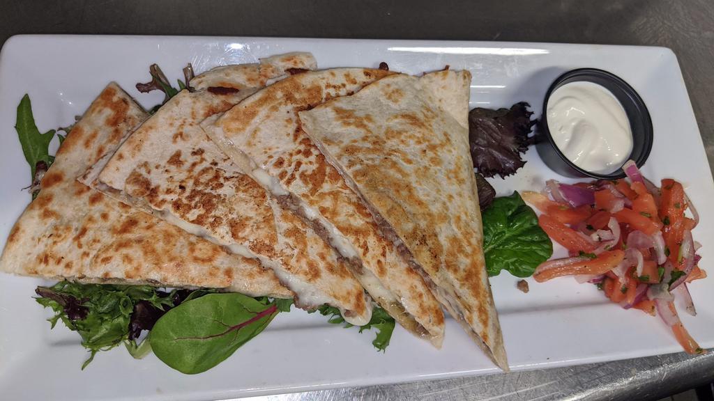 Quesadilla · Choice of chicken, beef, pork or cheese, served with pico de gallo and sour cream.