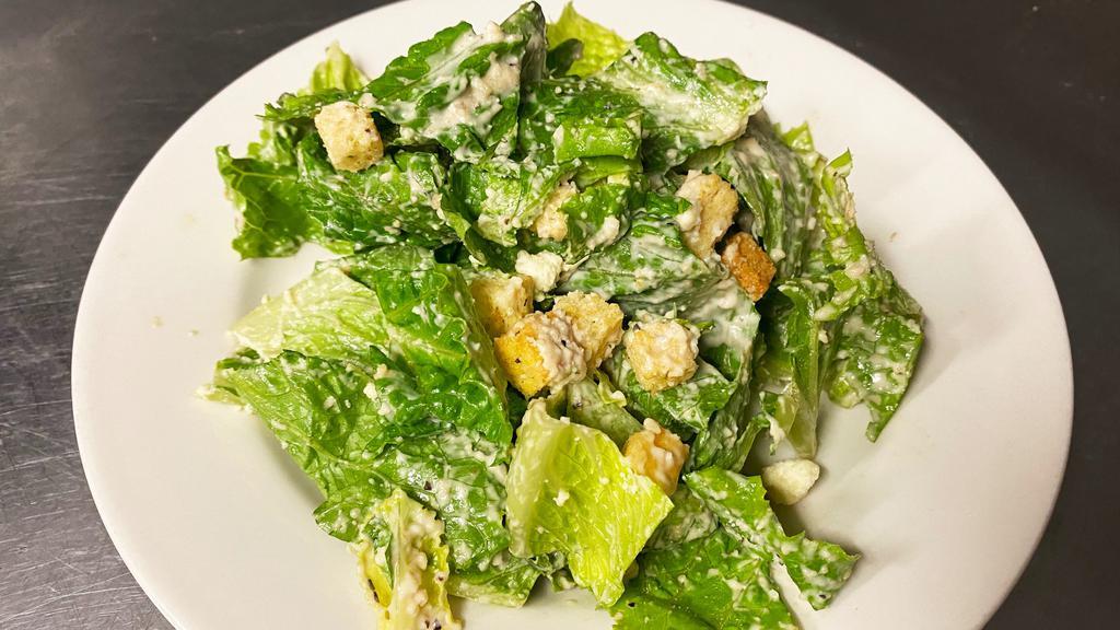 Caesar Salad · Romaine lettuce and croutons dressed with caesar dressing, parmesan cheese, and black pepper.