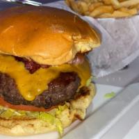 Bacon Cheddar Burger · 9oz 100% beef patty, bacon, cheddar cheese, lettuce, tomato & mayo/ketchup sauce on a toaste...