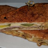 Cuban Sandwich · Slow roasted pork, glazed ham, Swiss cheese, thinly sliced dill pickles and mustard in a toa...
